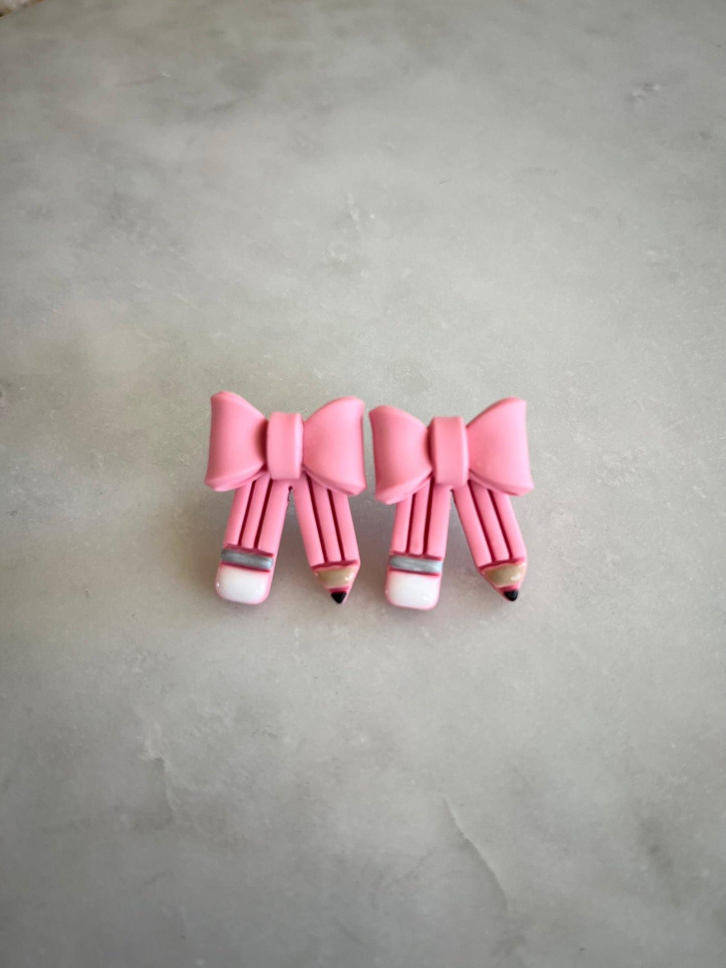 Pink pencil bow studs